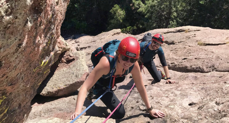 A pair climbing rock wall cracks in search of conquering yet another wall.