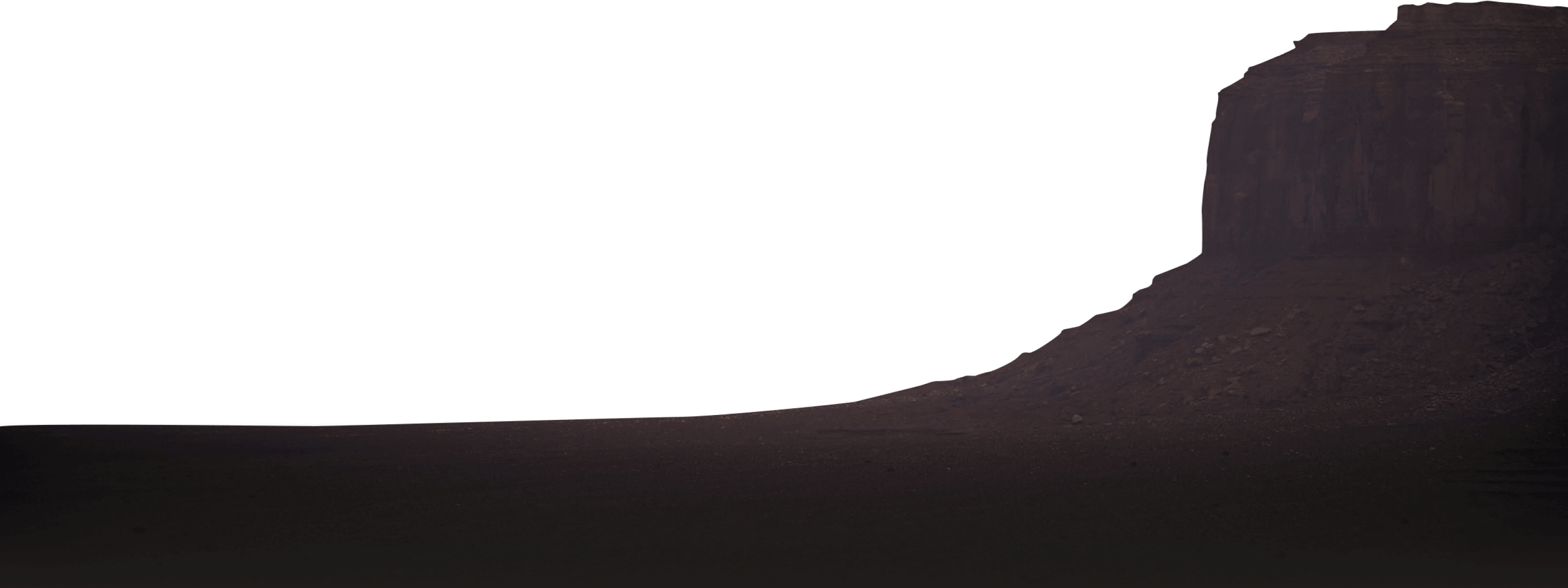 A sandstone rock formation soaked in shadow.
