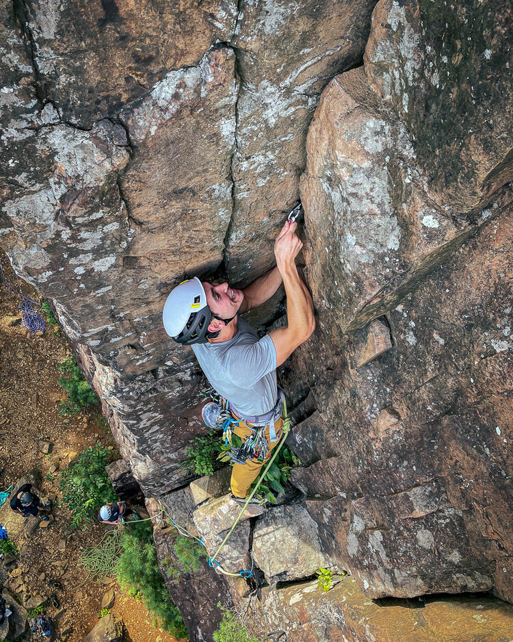 A person rock climbing in Ragged Mountains