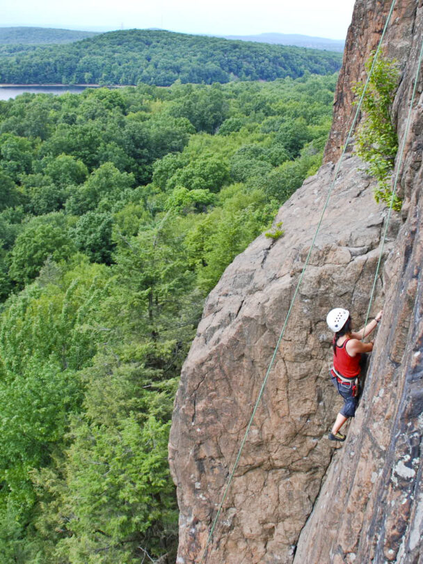 A person rock climbing in Ragged Mountains
