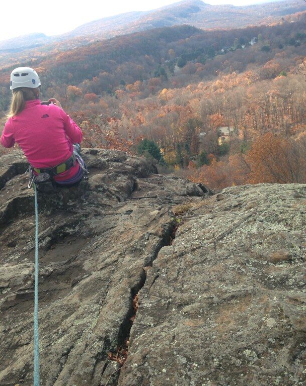 A person rock climbing in Ragged Mountains