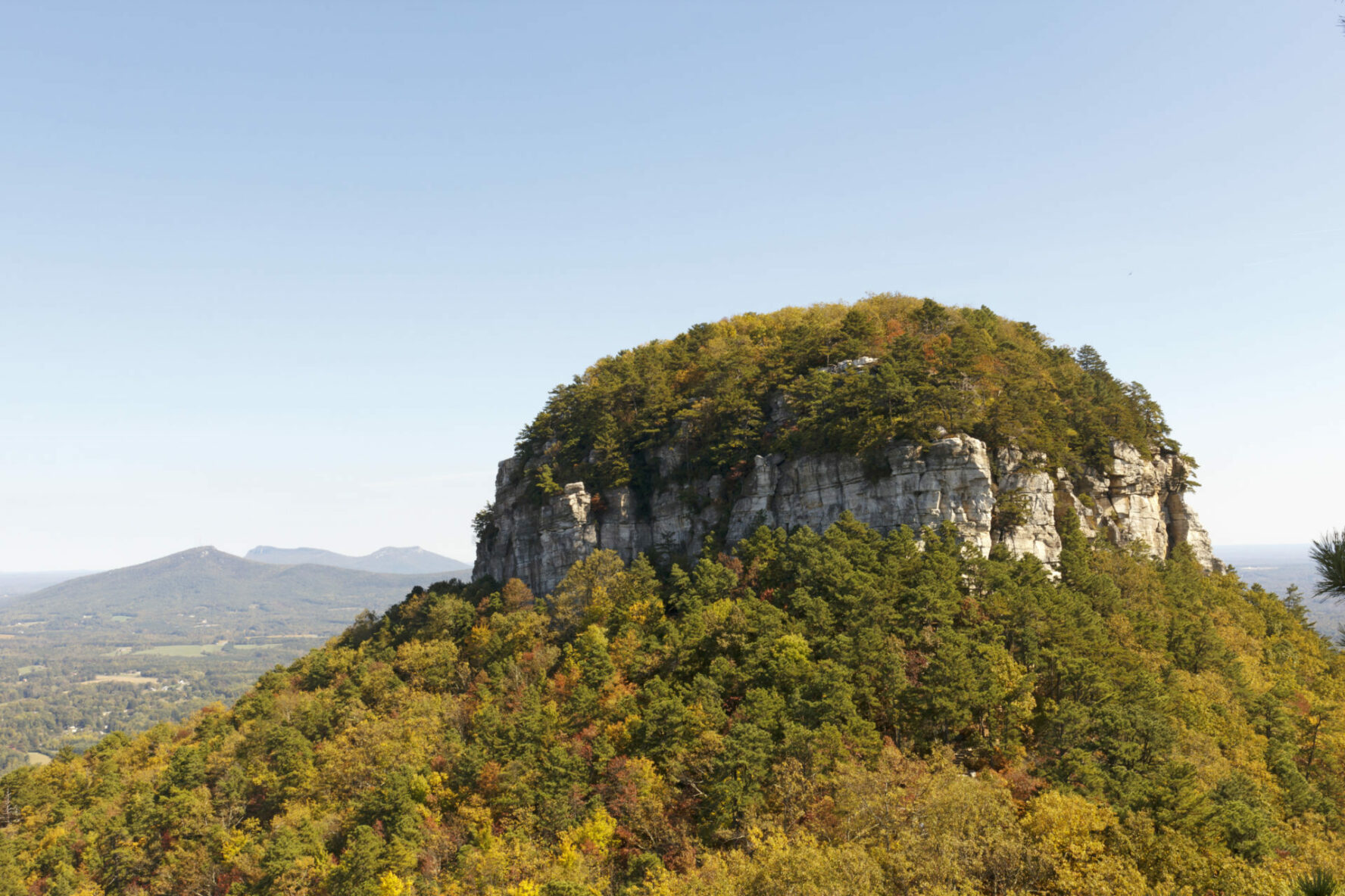 Pilot MountainThe pinnacle, in NC, 1400 feet above the valley floor, is quartzite metamorphic rock produced millions of years ago by pressure and heat below earth's surface, rock climbing north carolina