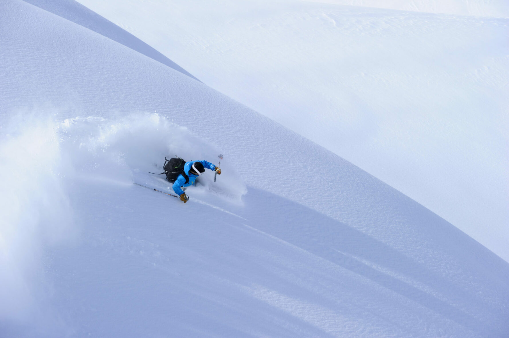 A skier making a turn in fluffy powder snow in Monarch Pass.