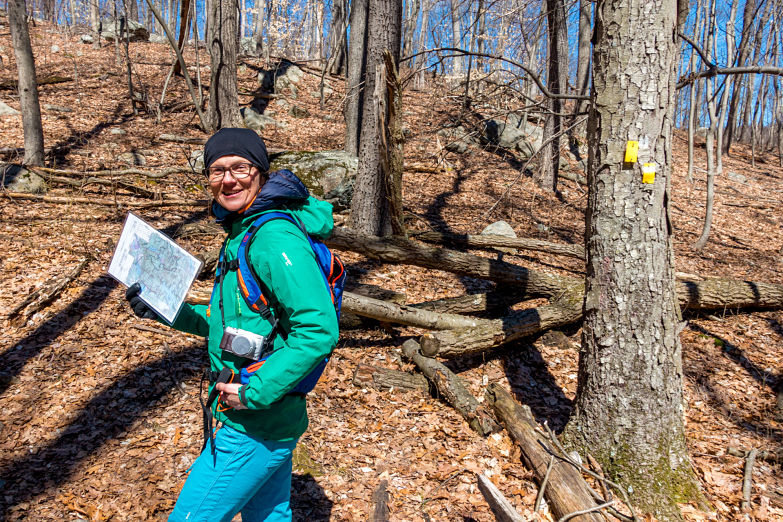 Karmen leads on the “Yellow” trail. The blazes say turn left.