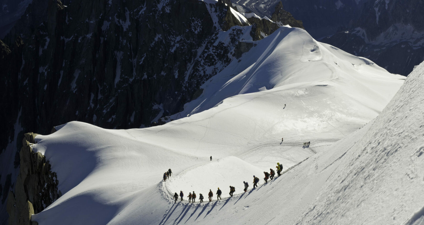 Skiers making their way down the ridge into La Valle Blanche