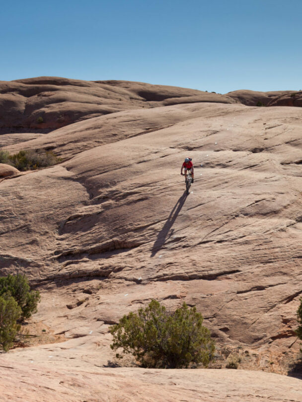 3 people riding a mountain bike in Moab, Utah