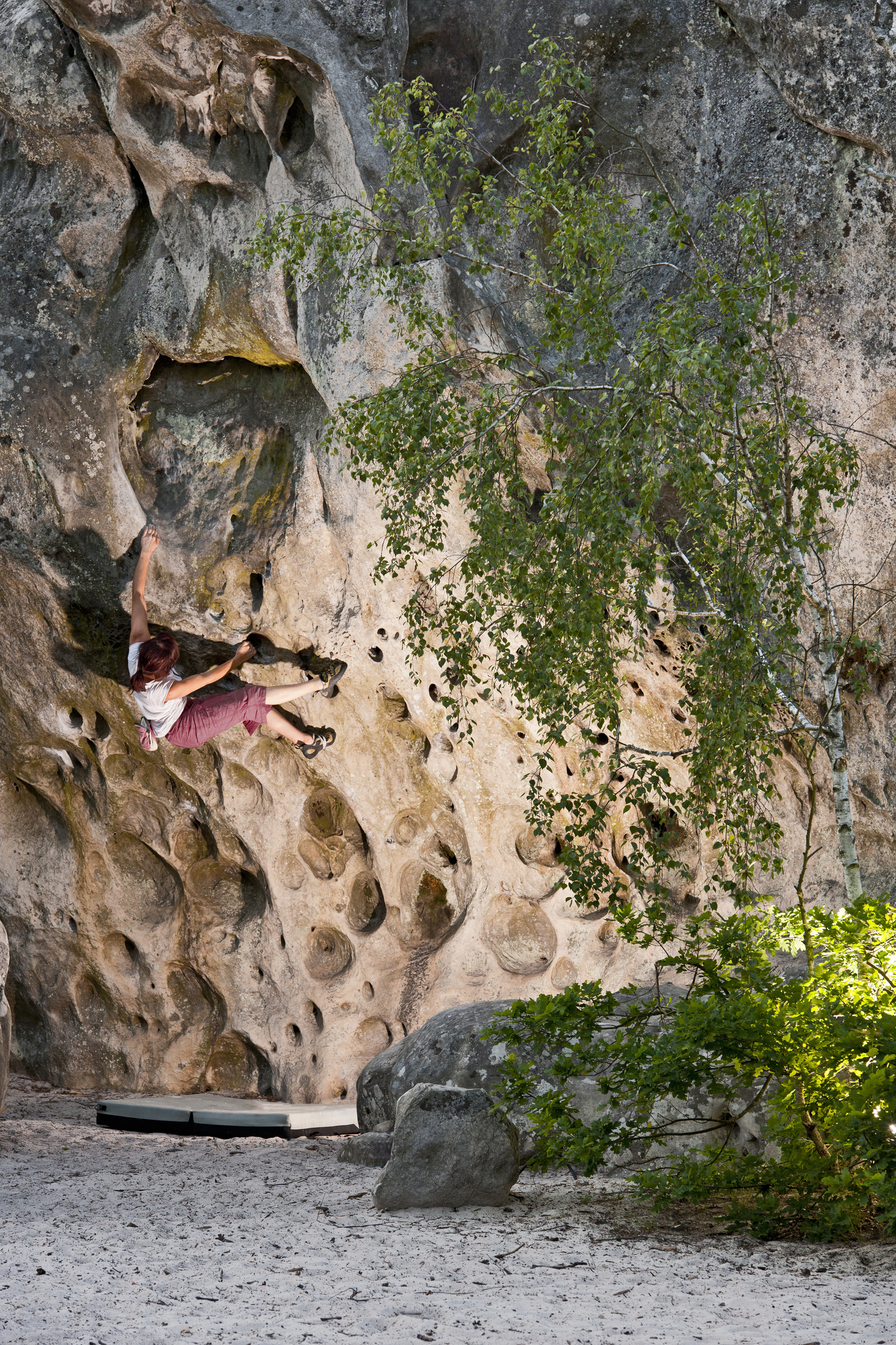 Man climbing rock face in Fontainbleau