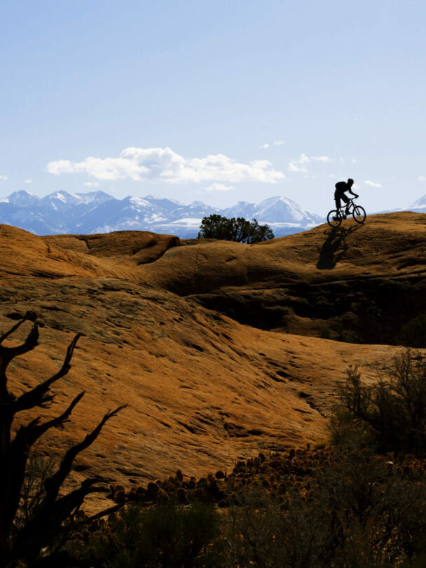 3 people riding a mountain bike in Moab, Utah