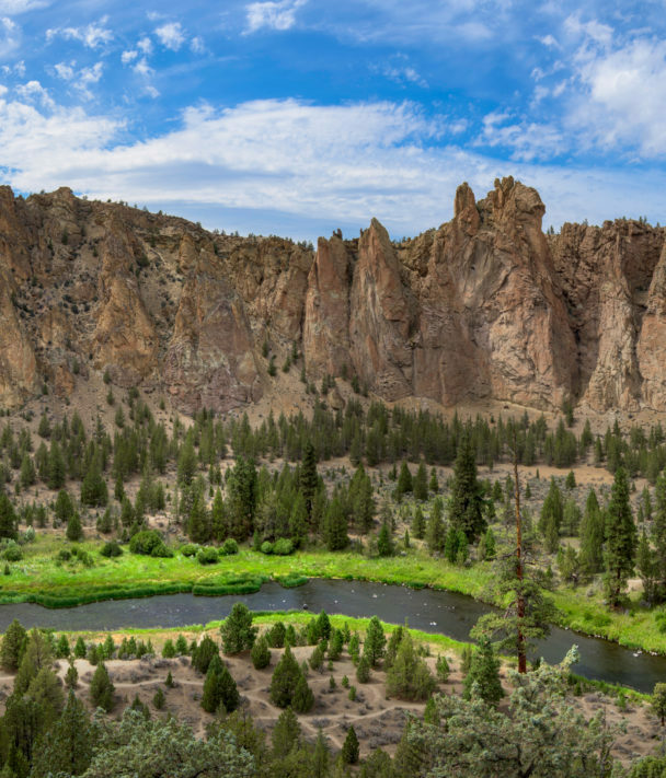 "A woman ascends a cliff at Smith Rock State Park, Oregon."