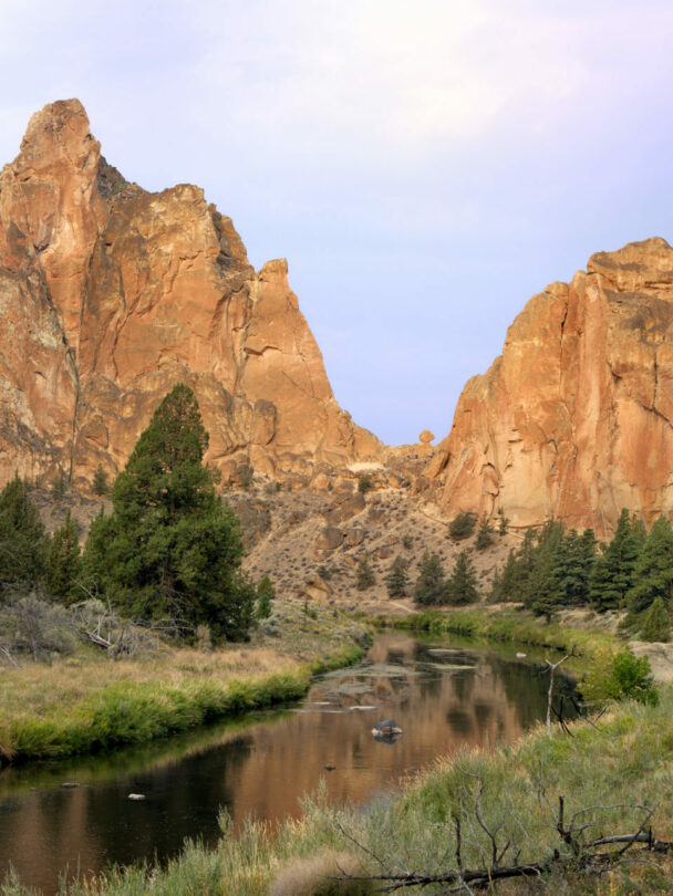 "A woman ascends a cliff at Smith Rock State Park, Oregon."