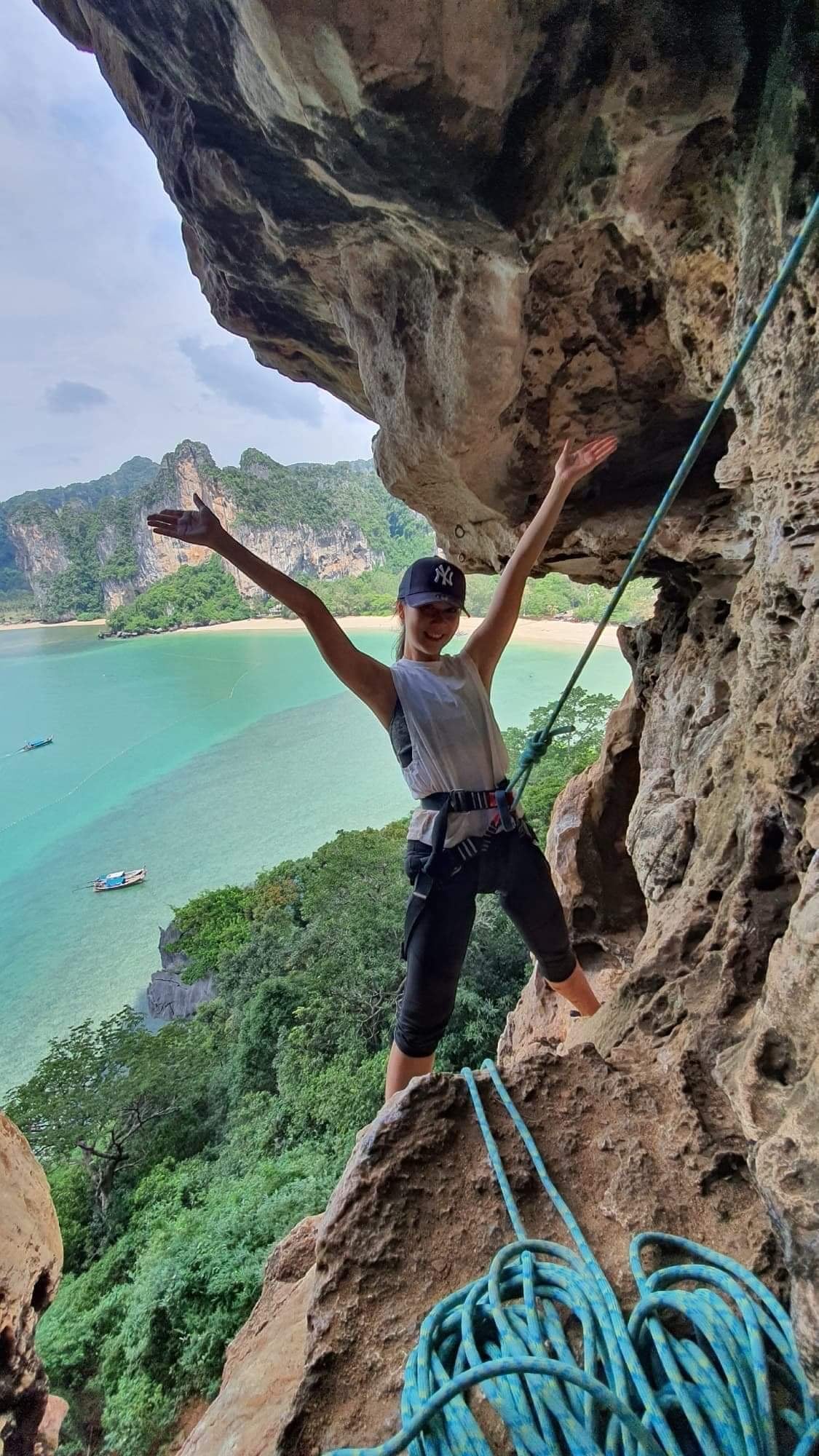 A woman posing and climbing in Railay, Thailand