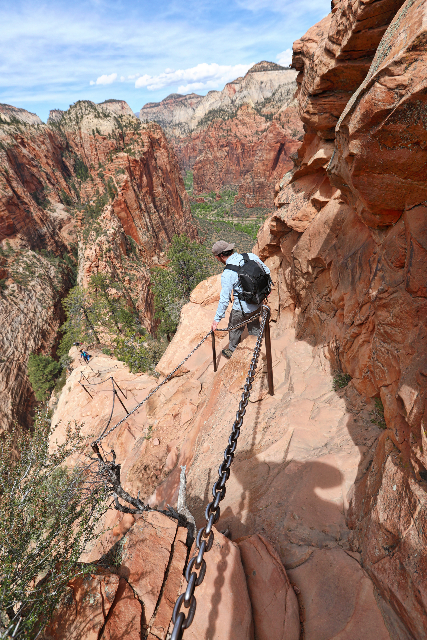 Young man hipster hiking Angels Landing trail in Zion National Park. Utah, USA