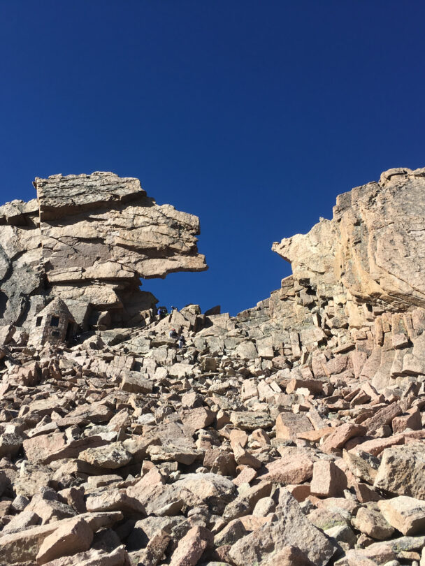 "Female climber makes the traverse from one line to the next on the fourth pitch of Orange Julius - Lumpy Ridge, Rocky Mountain National Park."