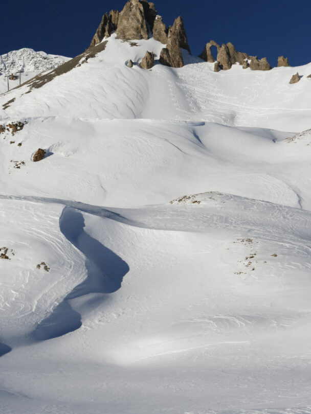 Female skier stopping to appreciate a magnificent view across the French Alps