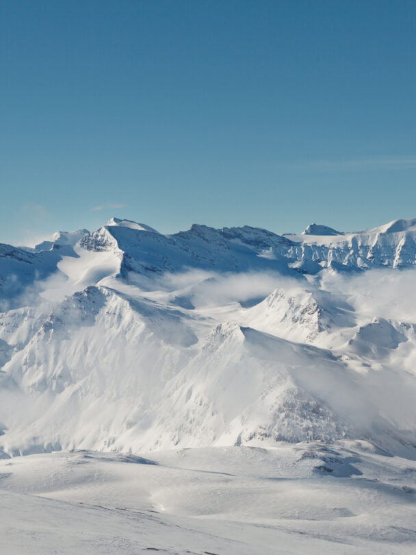 Female skier stopping to appreciate a magnificent view across the French Alps