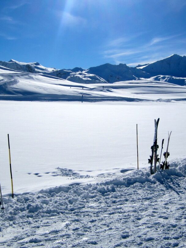 Female skier stopping to appreciate a magnificent view across the French Alps