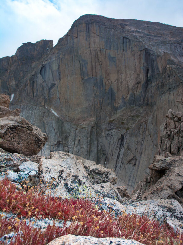 "Female climber makes the traverse from one line to the next on the fourth pitch of Orange Julius - Lumpy Ridge, Rocky Mountain National Park."