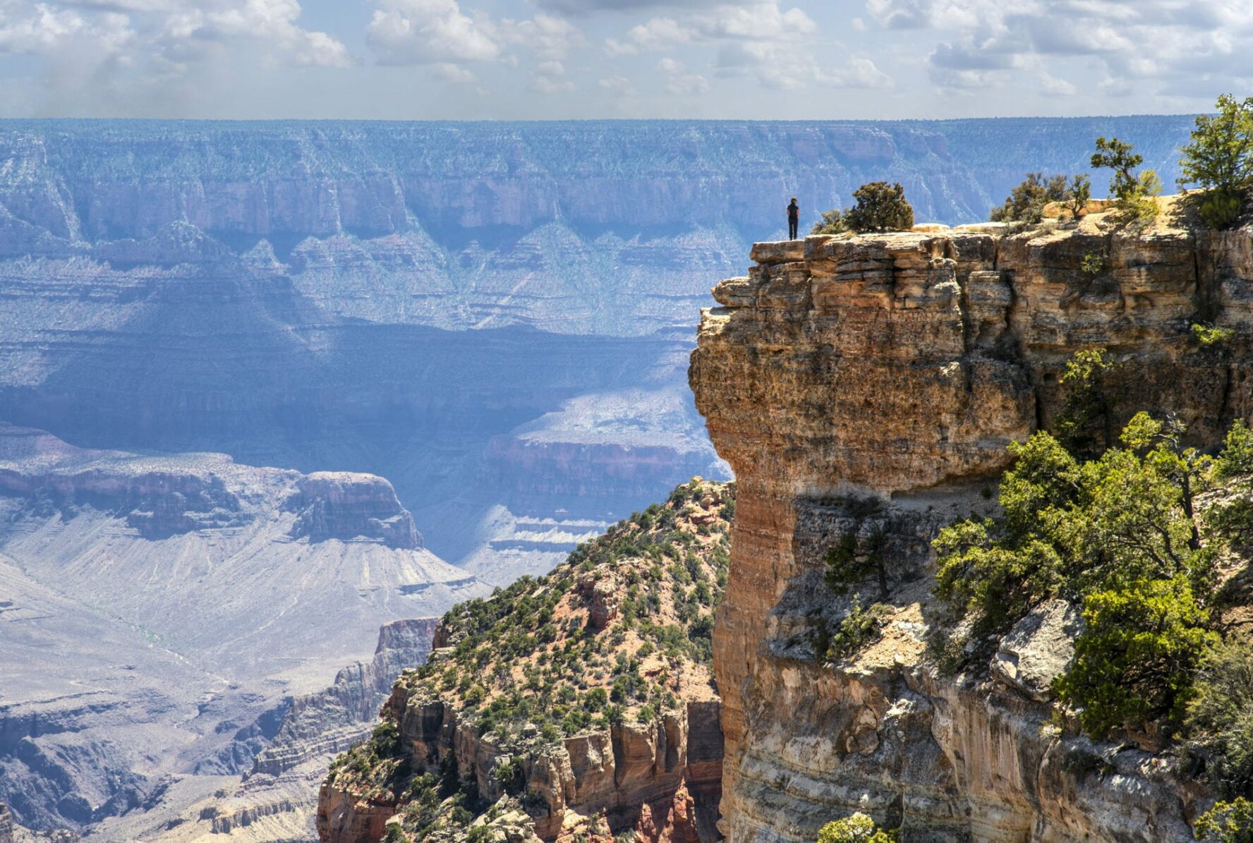 A hiker admiring the viewpoint on the Cape Royal Trail.