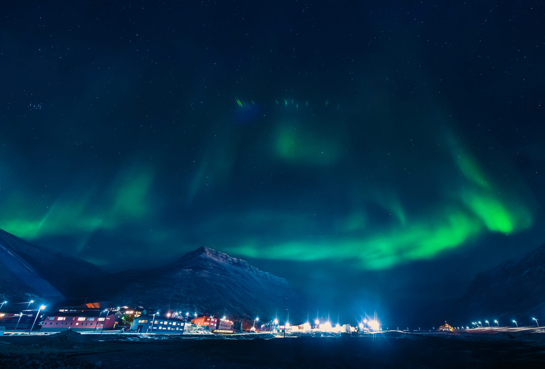 The polar arctic Northern lights aurora borealis sky star in Norway Svalbard in Longyearbyen city the moon mountains
