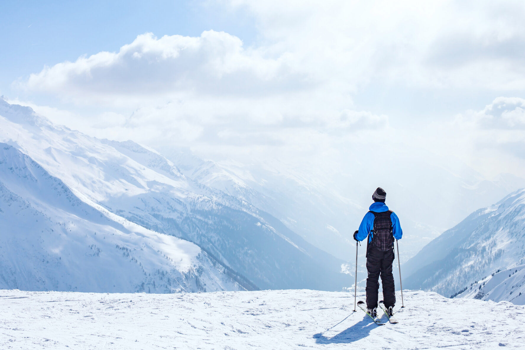 A man standing on the snowy mountaintop, enjoying the view of the Chamonix area