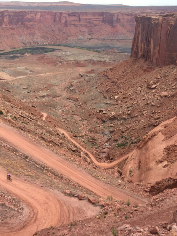 3 people riding a mountain bike in Moab, Utah