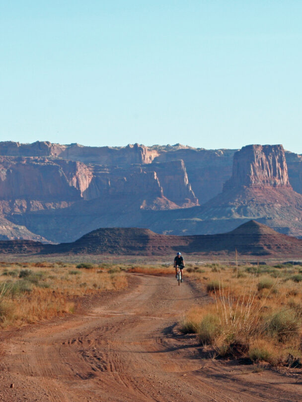3 people riding a mountain bike in Moab, Utah