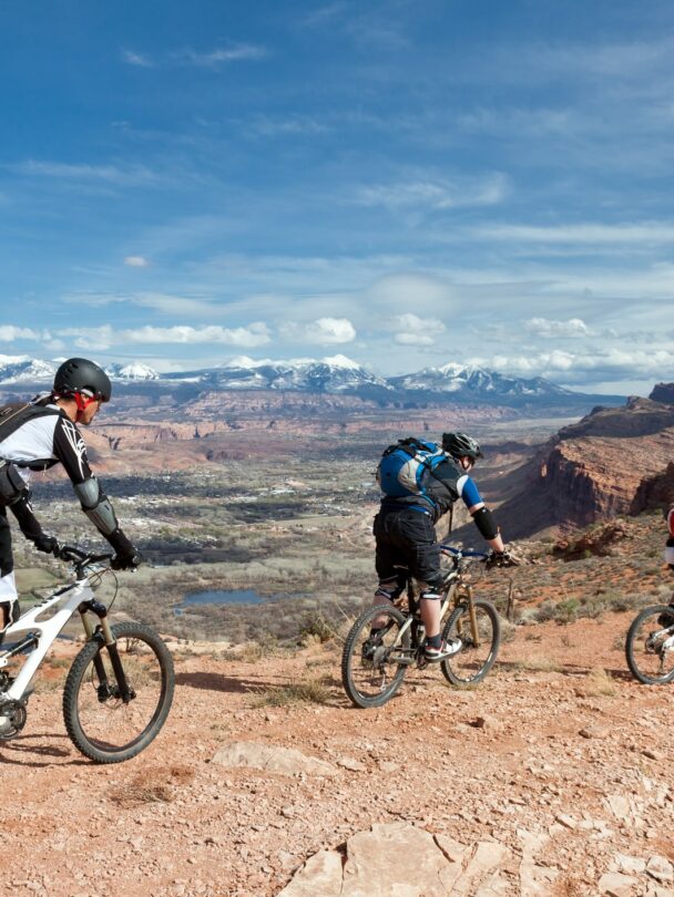 3 people riding a mountain bike in Moab, Utah
