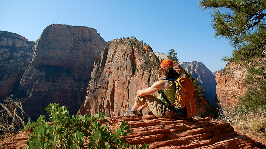 A hiker relaxing on an overlook in Zion National Park
