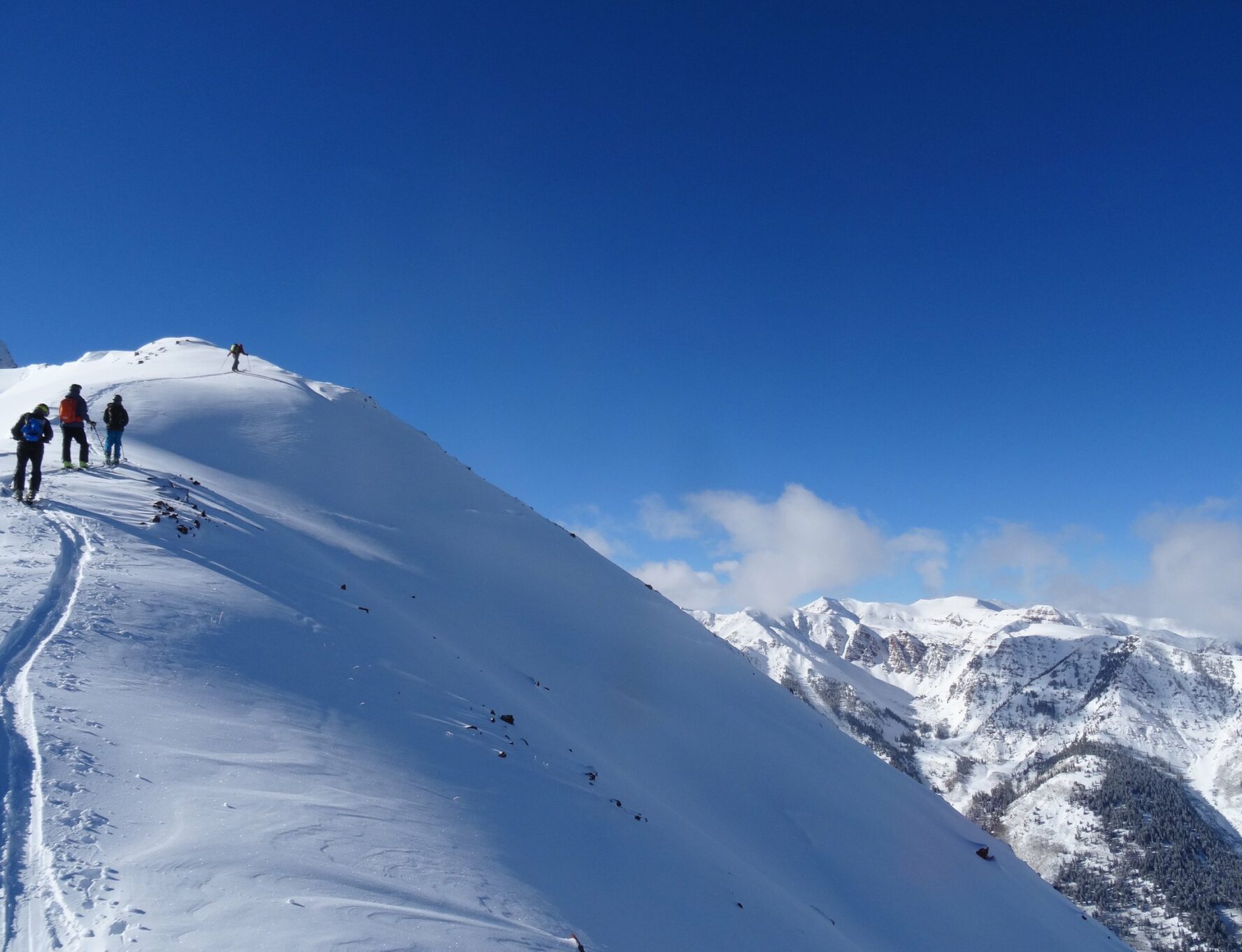 Skiers skinning up the hill