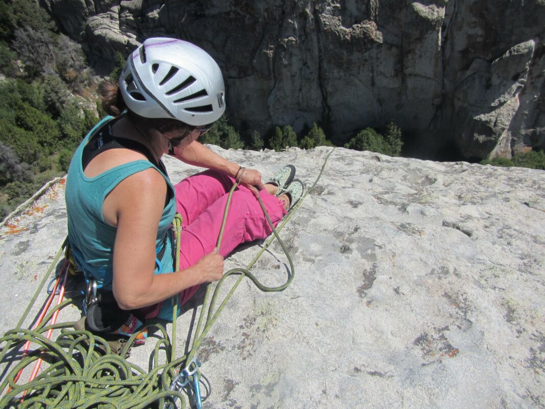 A woman belaying in City of Rocks