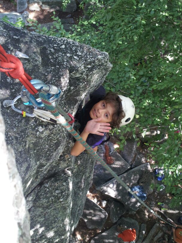 A young climber finishing a route in the Gunks