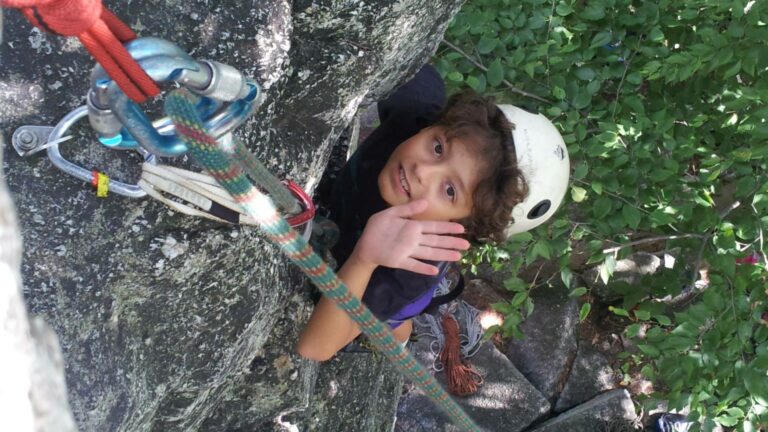 A young climber finishing a route in the Gunks