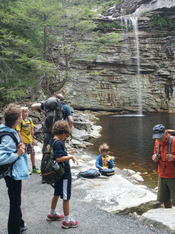 A young climber finishing a route in the Gunks