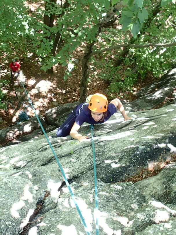 A young climber finishing a route in the Gunks