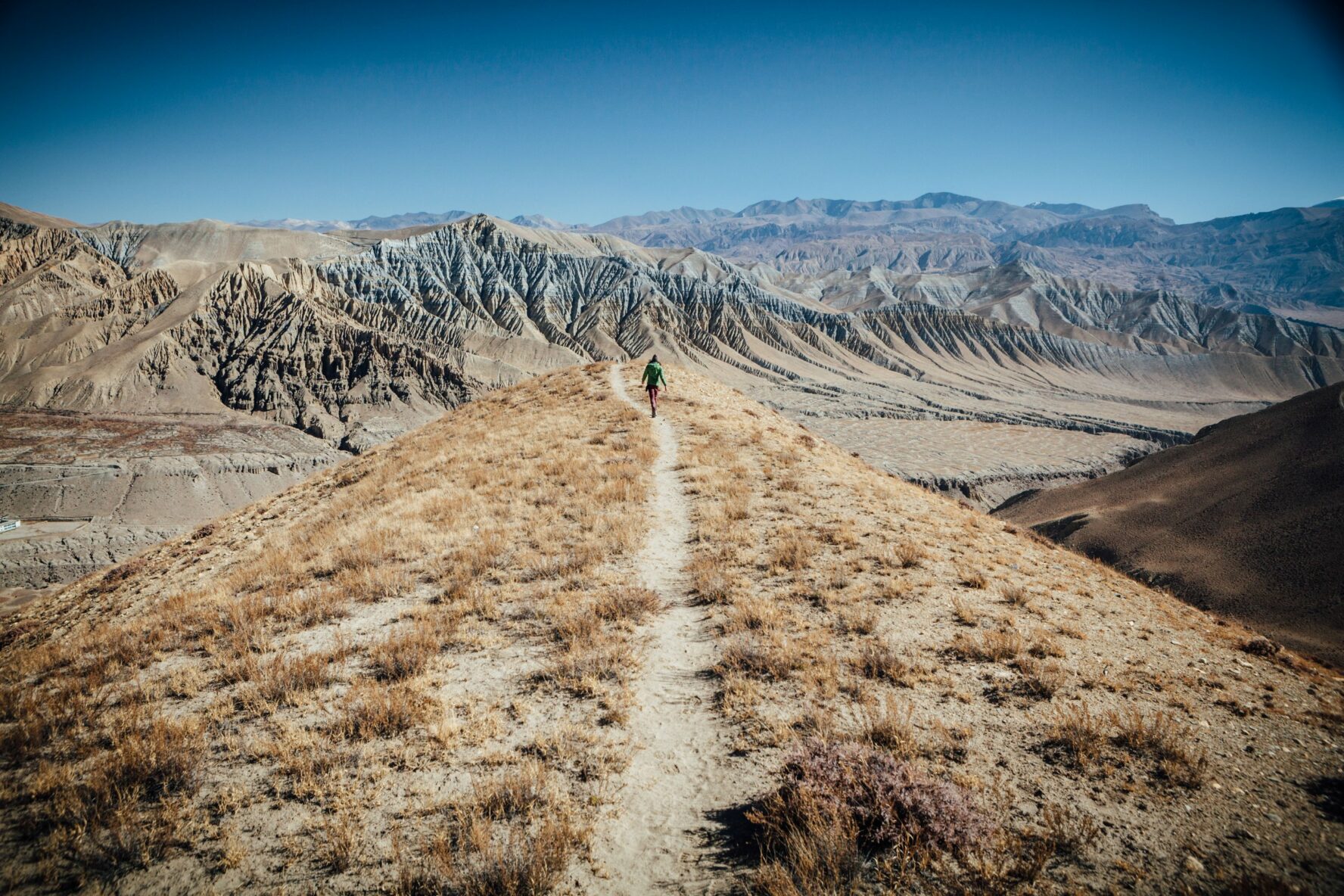 A man hiking on a trail in Upper Mustang