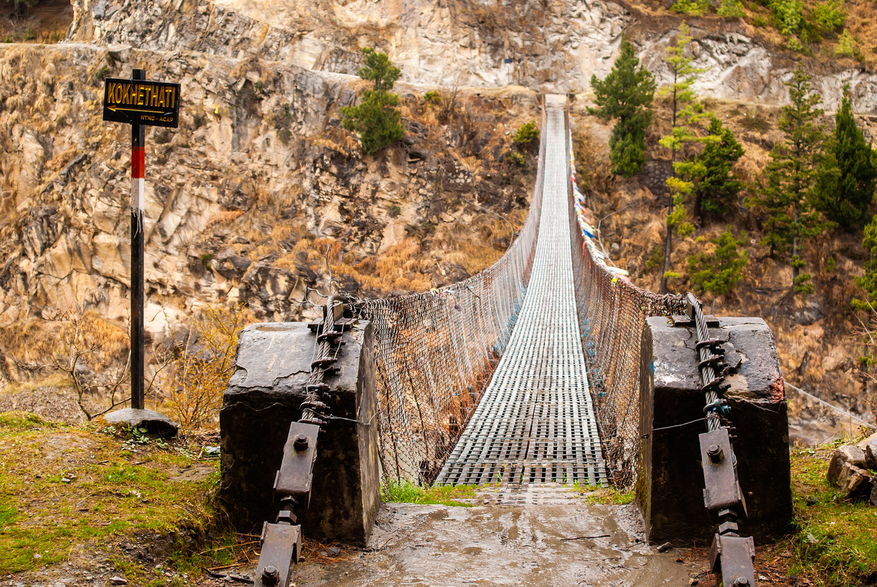 Picture of a suspension bridge over the mountain river. trekking in Himalaya mountains, Nepal. Annapurna circuit trek.