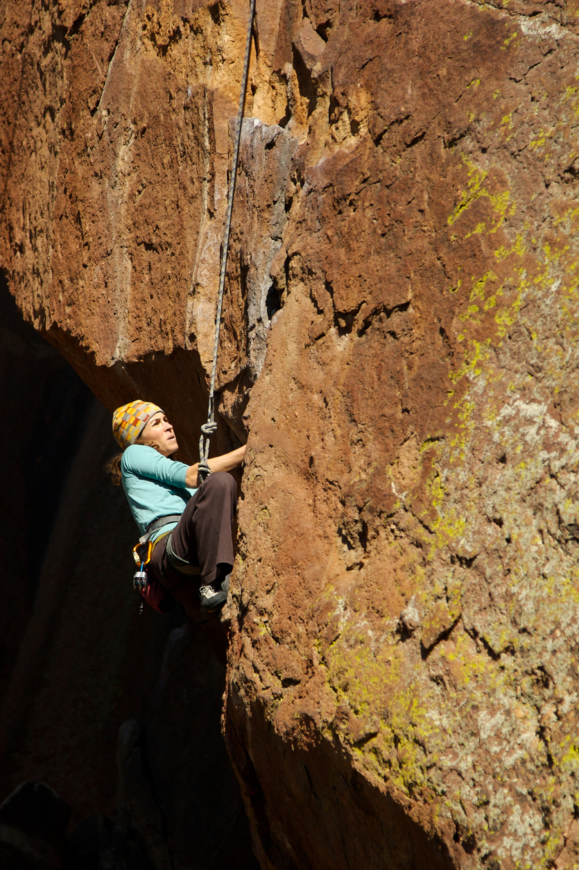 Female climber on wall of rock in Eldorado Canyon outside of Boulder, CO.