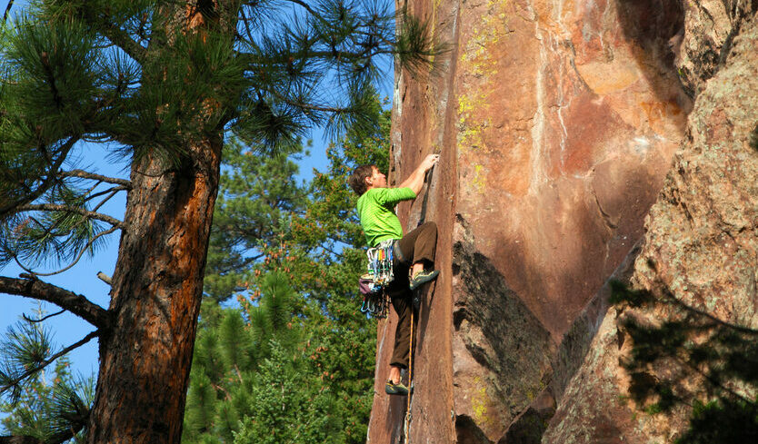 Climber on wall of rock in Eldorado Canyon outside of Boulder, CO.