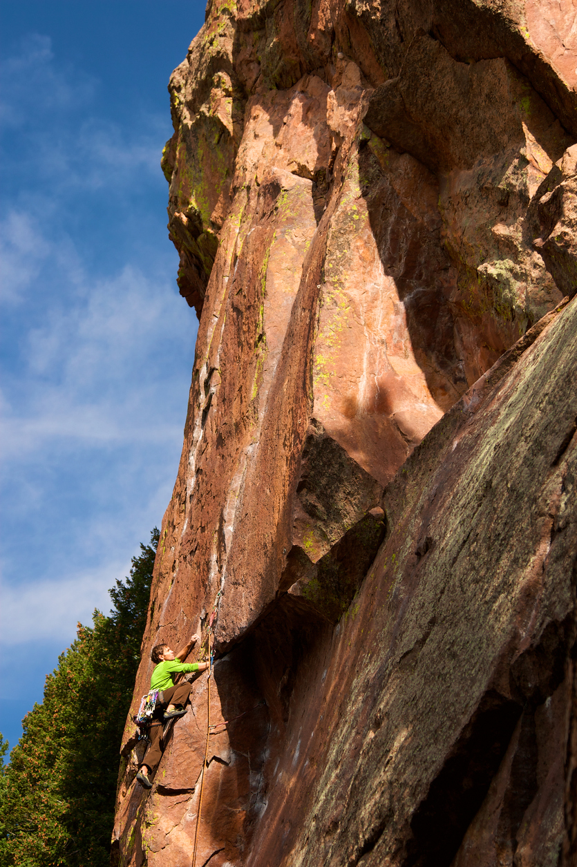 Climber on wall of rock in Eldorado Canyon outside of Boulder, CO.
