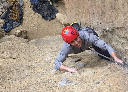 A woman nears the top of a spire at Smith Rock State Park, Oregon. The Crooked River is far below in the valley.