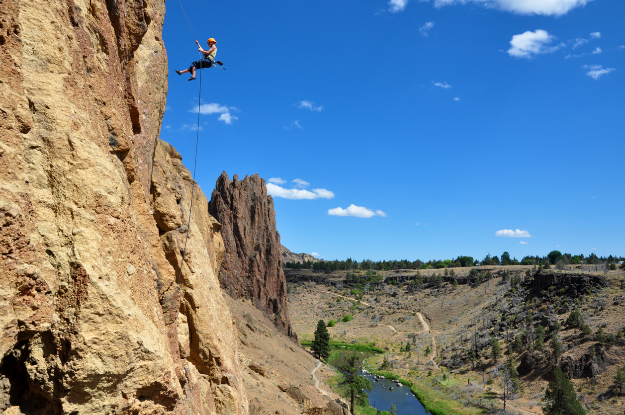 "A climber rappels from a cliff at Smith Rock State Park, Oregon."