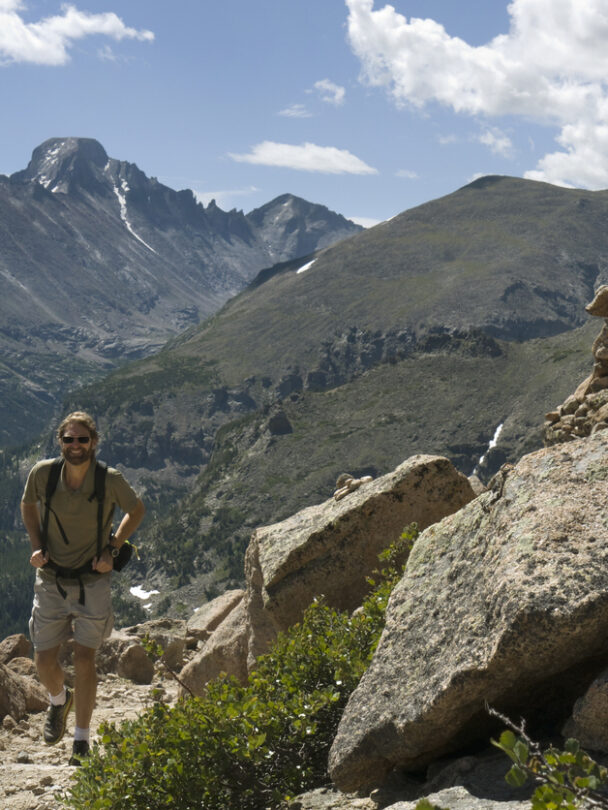 Longs Peak with trail map scene guiding your way many people die climbing this mountain. Estes Park , Colorado is near the Long Peak many many people attempt to climb this Peak and some do not survive. This shows the peak in Summer on a perfect day to climb. A colorado 14er