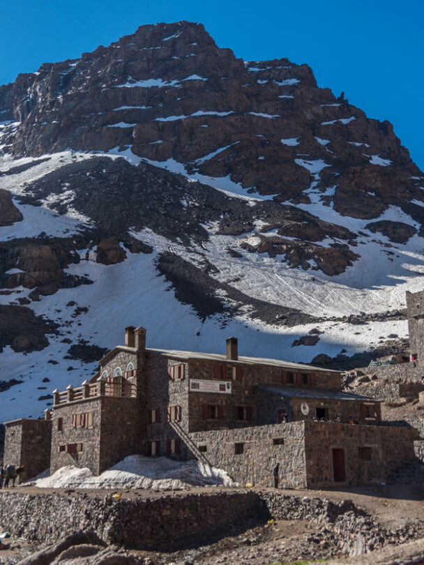 Toubkal national park in springtime with mount, cover by snow and ice, Refuge Toubkal, start point for hike to Jebel Toubkal, – highest peak of Atlas mountains and Morocco