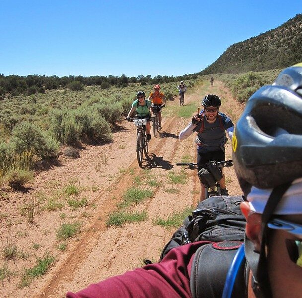 "mountain biker man on singletrack path surrounded by green mountain meadow while riding the colorado trail near molas pass in the san juan mountains above durango, colorado, usa. horizontal composition."