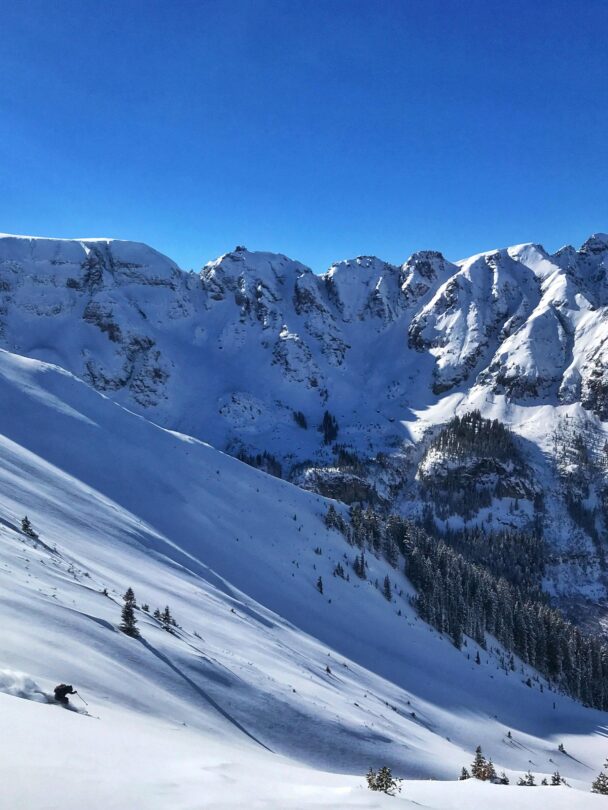 A skier enjoying the dawn from Telluride's snowy backcountry