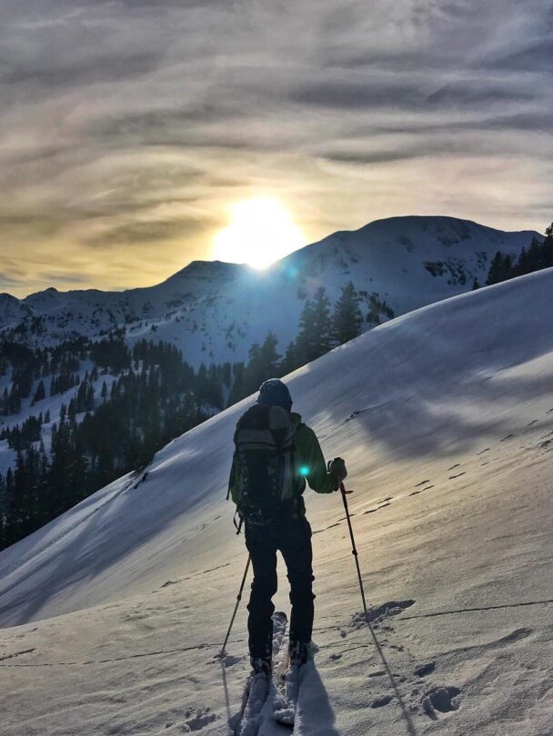 A skier enjoying the dawn from Telluride's snowy backcountry