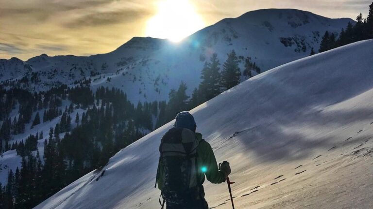 A skier enjoying the dawn from Telluride's snowy backcountry