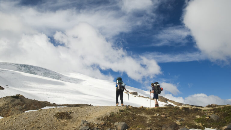 Hikers toward Easton glacier on the souther flank of Mt Baker - 10,781 ft. This image is taken on the Railroad Grade trail, Washington State.