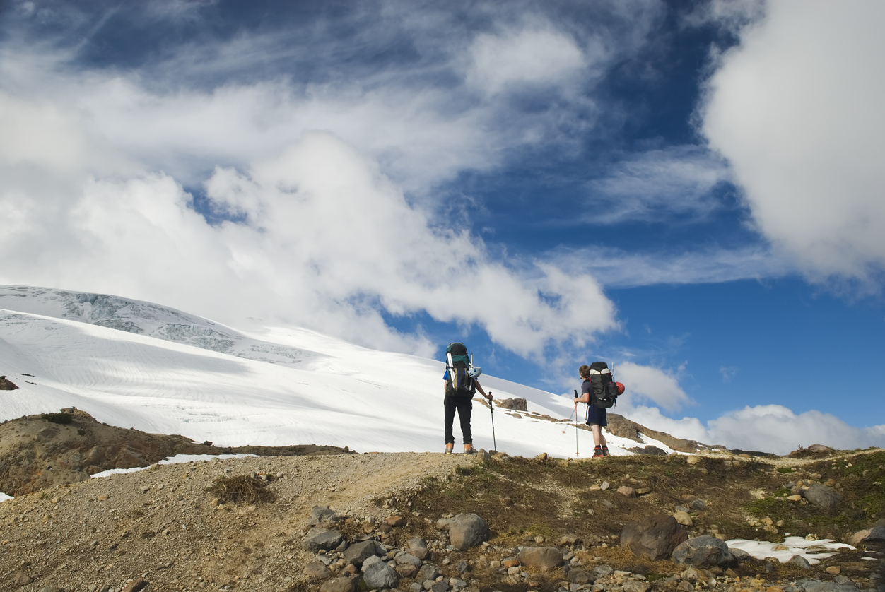 Hikers toward Easton glacier on the souther flank of Mt Baker - 10,781 ft. This image is taken on the Railroad Grade trail, Washington State.