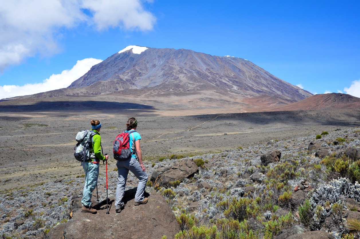 Two women overlook the Marangu Route on Mt. Kilimanjaro in Tanzania.